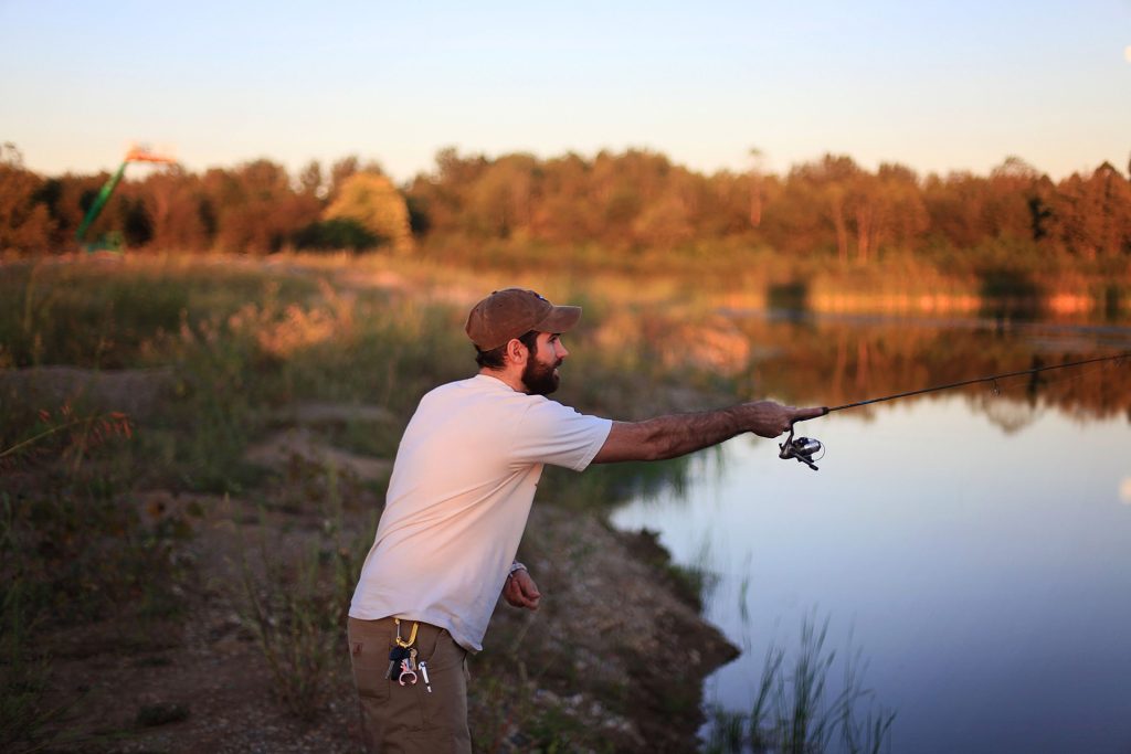 Man fishing by pond