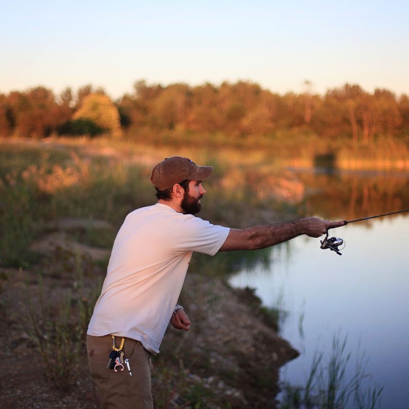 Man fishing by pond